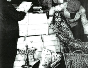 Inspection of seized clothes (source: http://collections.jewishmuseum.cz)