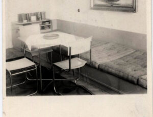 Confiscated apartment of Jewish residents. A room with a table, a cabinet and a metal bed (source: http://collections.jewishmuseum.cz)